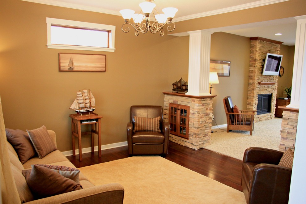 This is an example of a mid-sized arts and crafts formal enclosed living room in Minneapolis with beige walls, carpet, a standard fireplace, a stone fireplace surround and a wall-mounted tv.