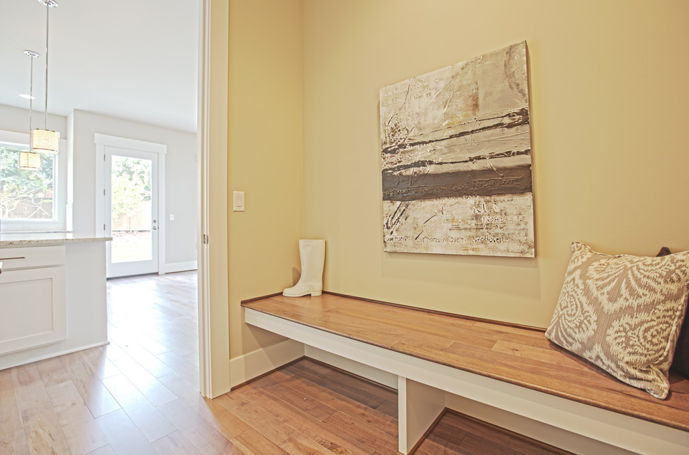 Photo of a large transitional hallway in Seattle with grey walls and medium hardwood floors.