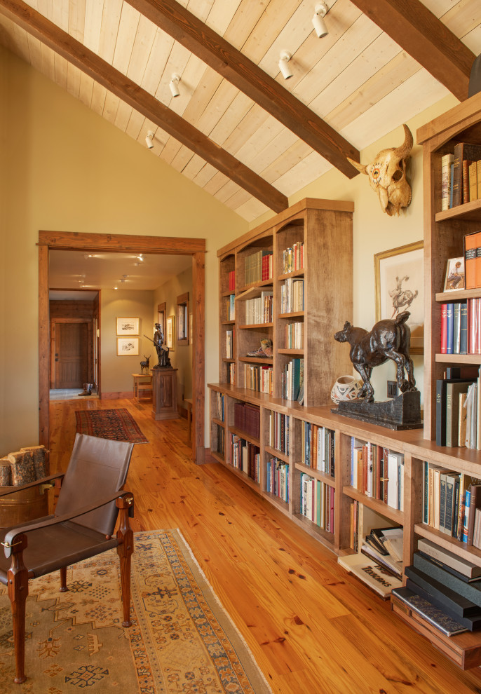 This is an example of a mid-sized country hallway in Other with beige walls, light hardwood floors and vaulted.