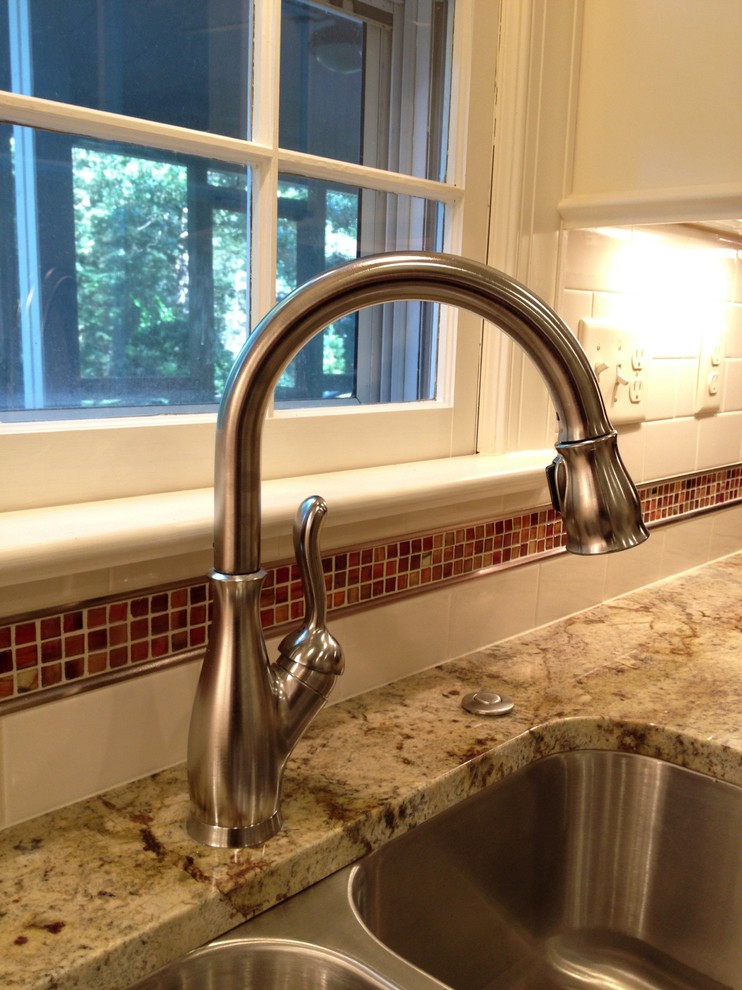 Mid-sized transitional u-shaped ceramic tile eat-in kitchen photo in Richmond with an undermount sink, raised-panel cabinets, white cabinets, granite countertops, white backsplash, subway tile backsplash, stainless steel appliances and a peninsula