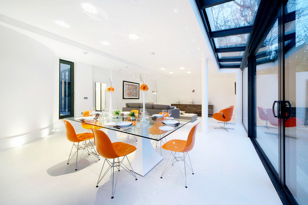 Photo of a contemporary open plan dining in London with white walls.