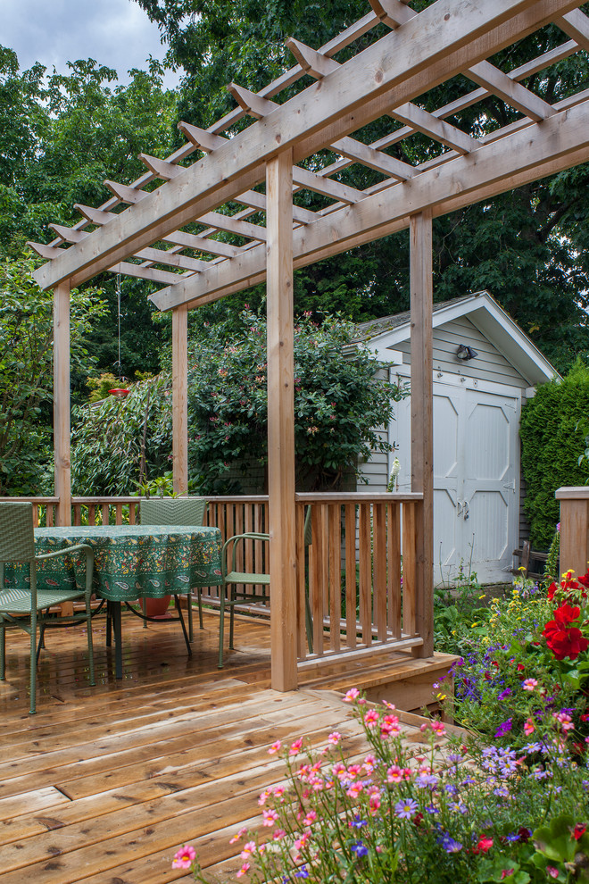 Mid-sized traditional backyard verandah in Portland with a container garden, decking and a pergola.