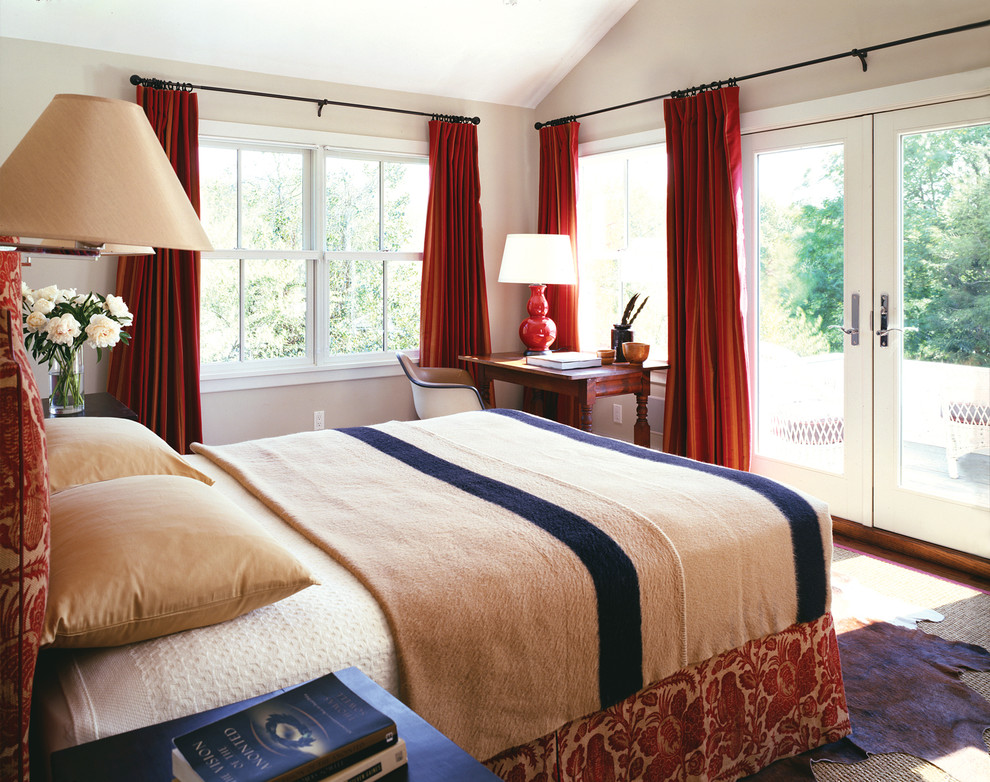 This is an example of a country bedroom in New York with beige walls.