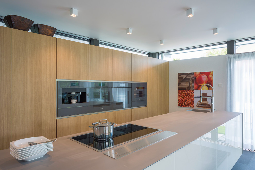 Design ideas for a large contemporary galley eat-in kitchen in Other with a single-bowl sink, flat-panel cabinets, medium wood cabinets, stainless steel benchtops, white splashback, timber splashback, stainless steel appliances, ceramic floors, a peninsula, grey floor and beige benchtop.