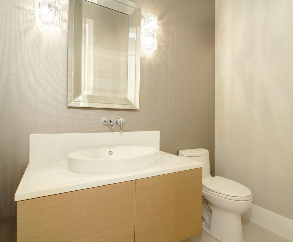 Design ideas for a small modern powder room in Vancouver with flat-panel cabinets, light wood cabinets, a one-piece toilet, beige walls, porcelain floors, a vessel sink, quartzite benchtops and beige floor.