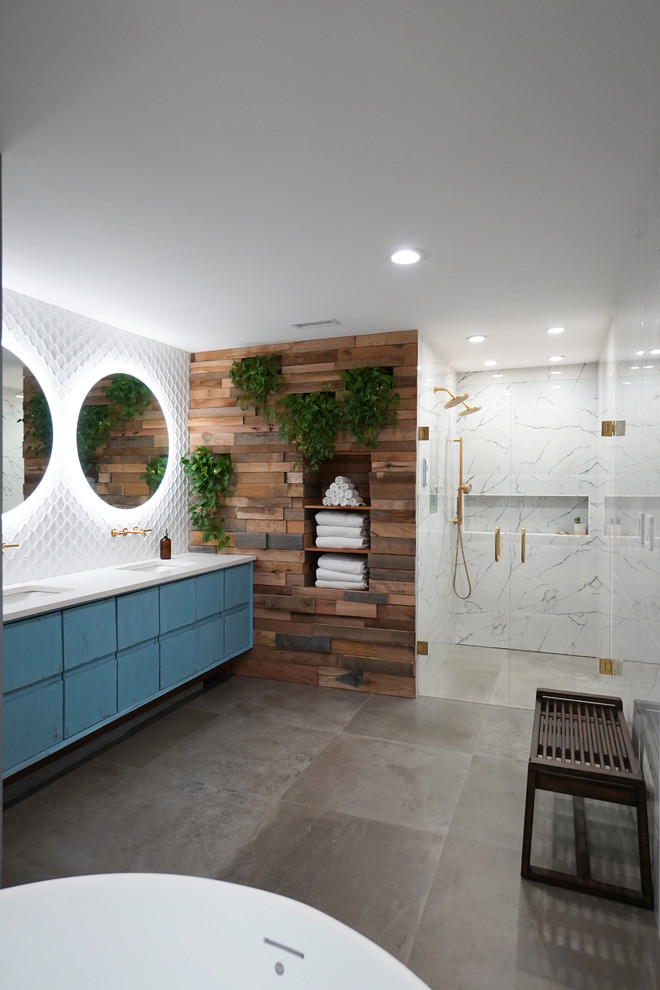 Inspiration for a large scandinavian master bathroom in Atlanta with flat-panel cabinets, blue cabinets, a freestanding tub, a curbless shower, a one-piece toilet, white tile, porcelain tile, blue walls, porcelain floors, an undermount sink, engineered quartz benchtops, grey floor, a hinged shower door and white benchtops.