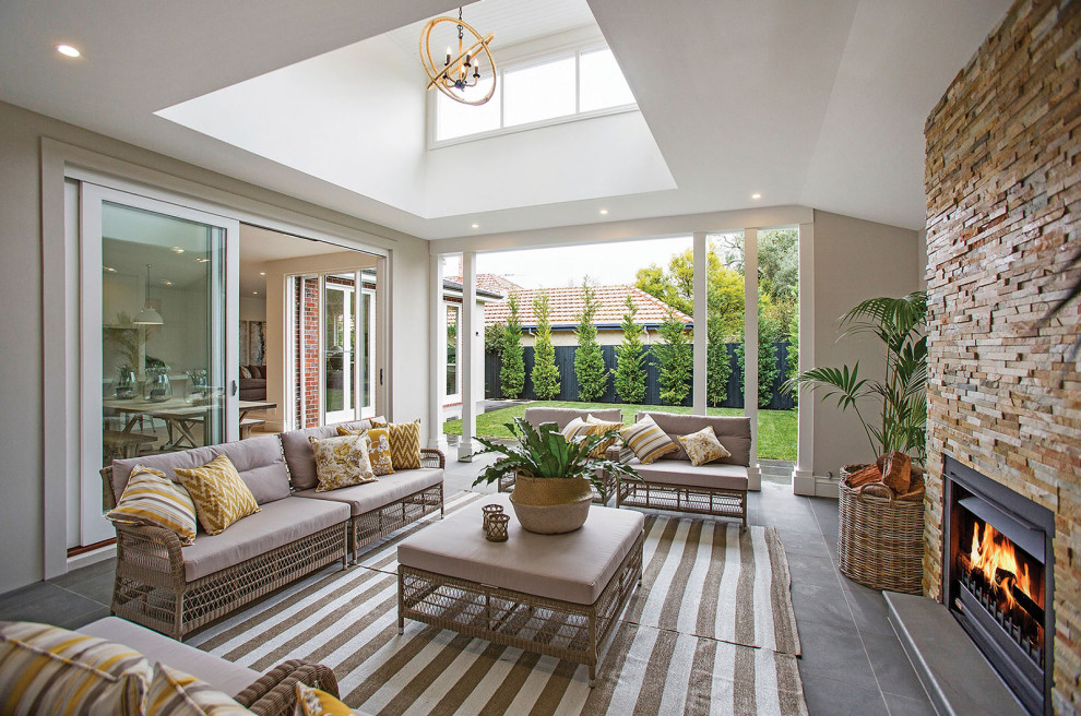 Inspiration for a transitional patio in Melbourne with tile and a roof extension.