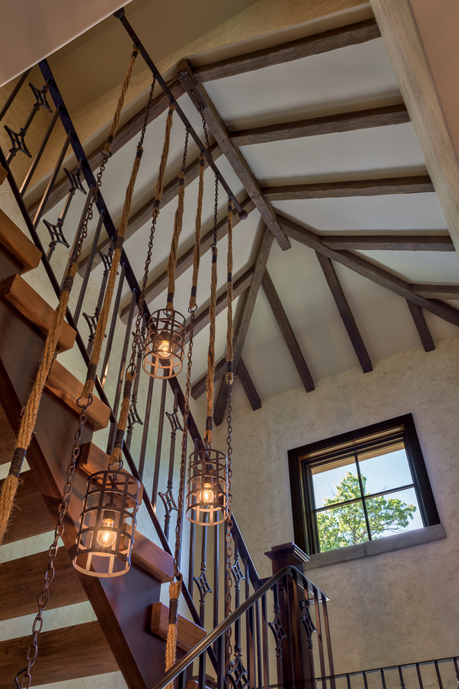 Mid-sized mountain style wooden u-shaped open and metal railing staircase photo