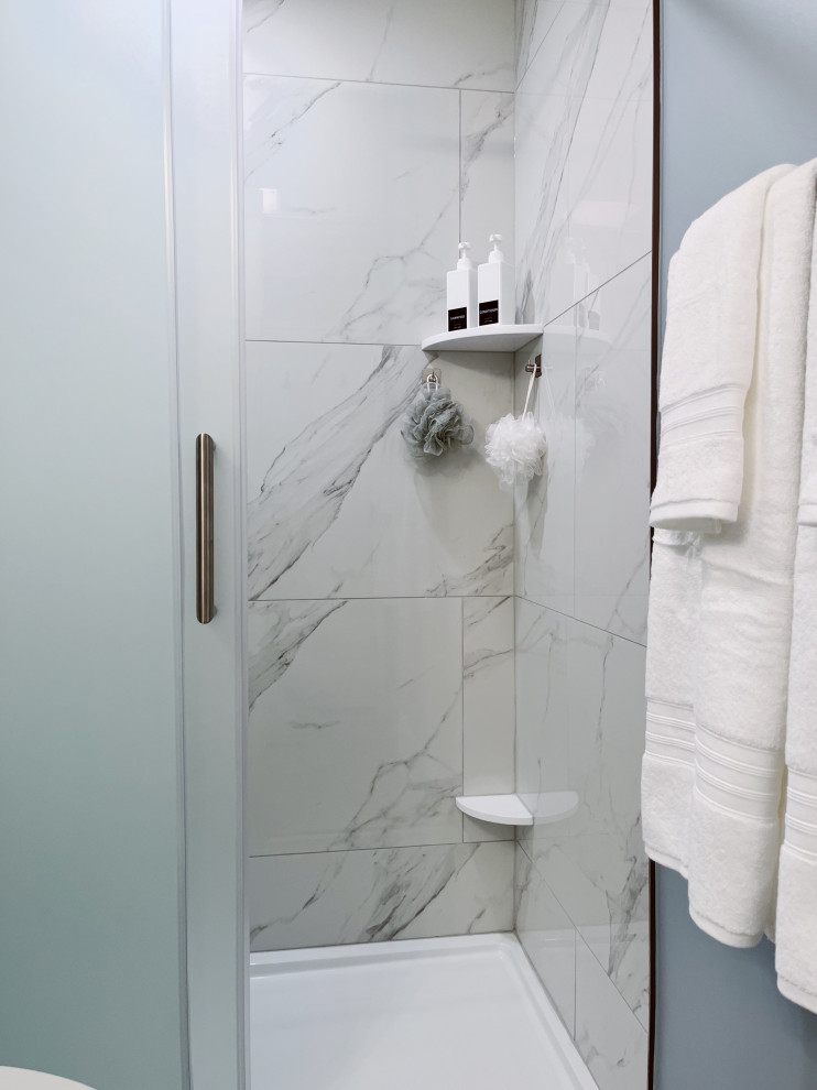 Inspiration for a small transitional kids' white tile and porcelain tile porcelain tile, white floor and single-sink alcove shower remodel with shaker cabinets, white cabinets, a two-piece toilet, blue walls, an undermount sink, marble countertops, gray countertops and a freestanding vanity