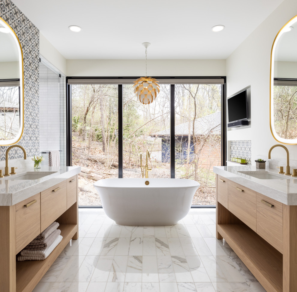 Photo of a large transitional master bathroom in Detroit with light wood cabinets, a freestanding tub, a curbless shower, multi-coloured tile, marble, multi-coloured walls, terra-cotta floors, white floor, white benchtops, a double vanity, a freestanding vanity, flat-panel cabinets and an undermount sink.