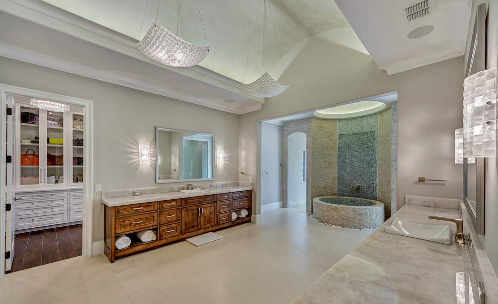 Huge transitional master white tile and stone tile limestone floor and white floor freestanding bathtub photo in Orange County with shaker cabinets, dark wood cabinets, a one-piece toilet, gray walls, a drop-in sink and quartzite countertops