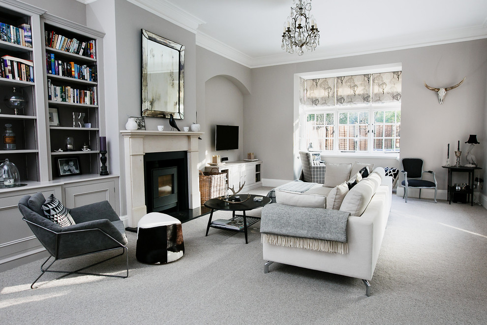 Transitional open concept family room in Surrey with beige walls, carpet, a standard fireplace and a wall-mounted tv.
