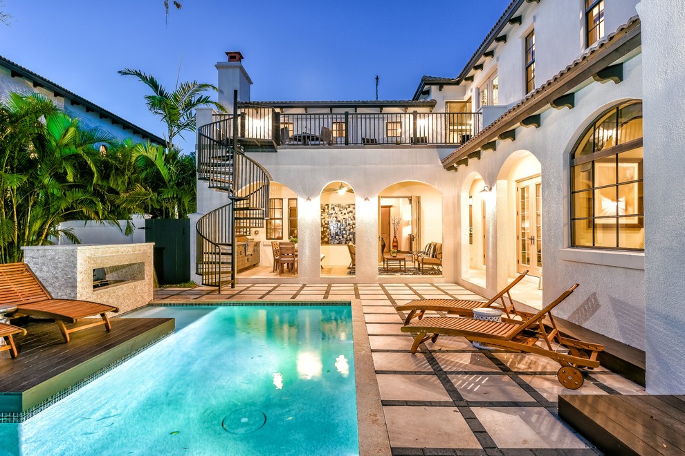 Inspiration for a large mediterranean side yard custom-shaped pool in Tampa with tile.