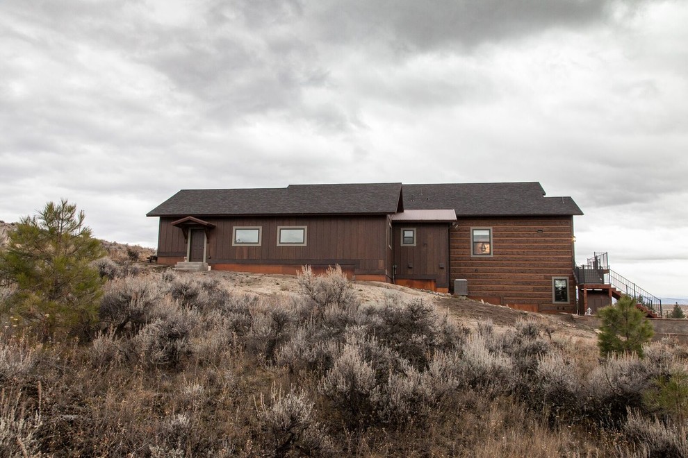 Large rustic brown two-story wood gable roof idea with a shingle roof