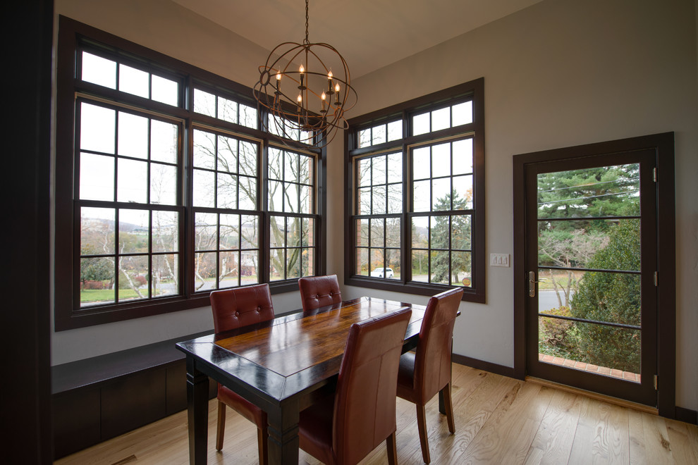 Photo of a contemporary dining room in Other with grey walls and medium hardwood floors.