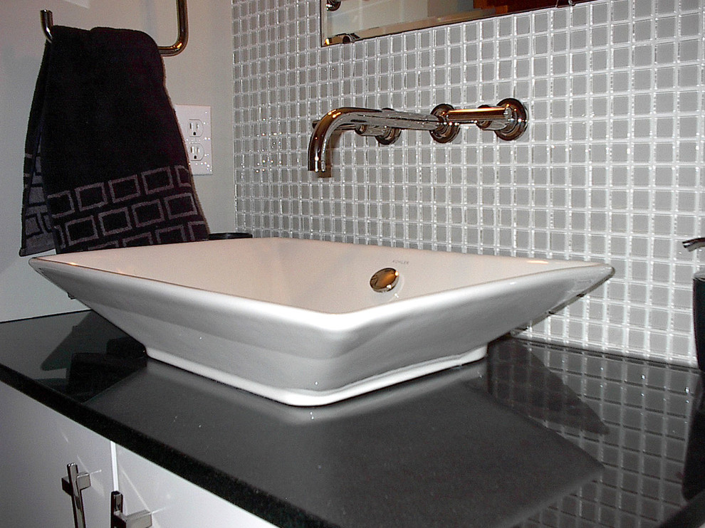 Inspiration for a small contemporary gray tile and glass tile home design remodel with flat-panel cabinets, white cabinets, gray walls, a vessel sink and quartzite countertops