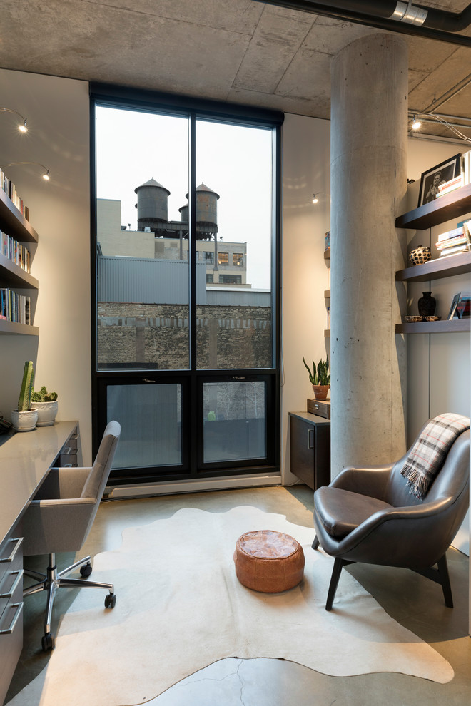 Inspiration for an industrial home office in Minneapolis with white walls, concrete floors and grey floor.