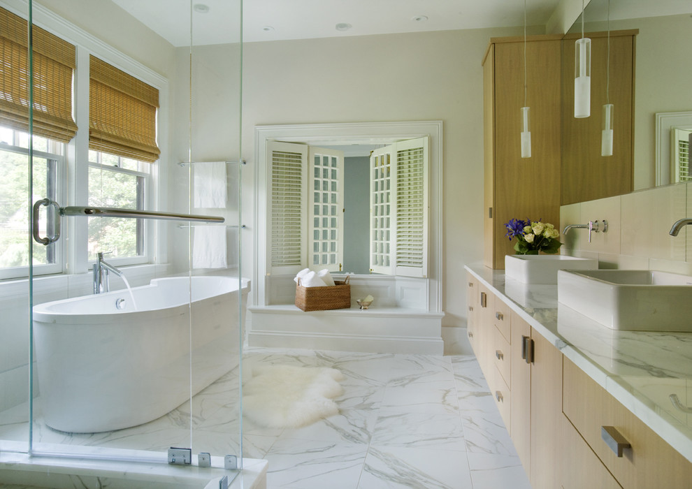 Inspiration for a contemporary bathroom in Boston with a vessel sink, a freestanding tub, marble floors and grey floor.