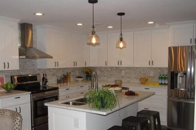 Example of a transitional l-shaped dark wood floor eat-in kitchen design in Boston with a double-bowl sink, shaker cabinets, white cabinets, marble countertops, gray backsplash, brick backsplash, stainless steel appliances and an island