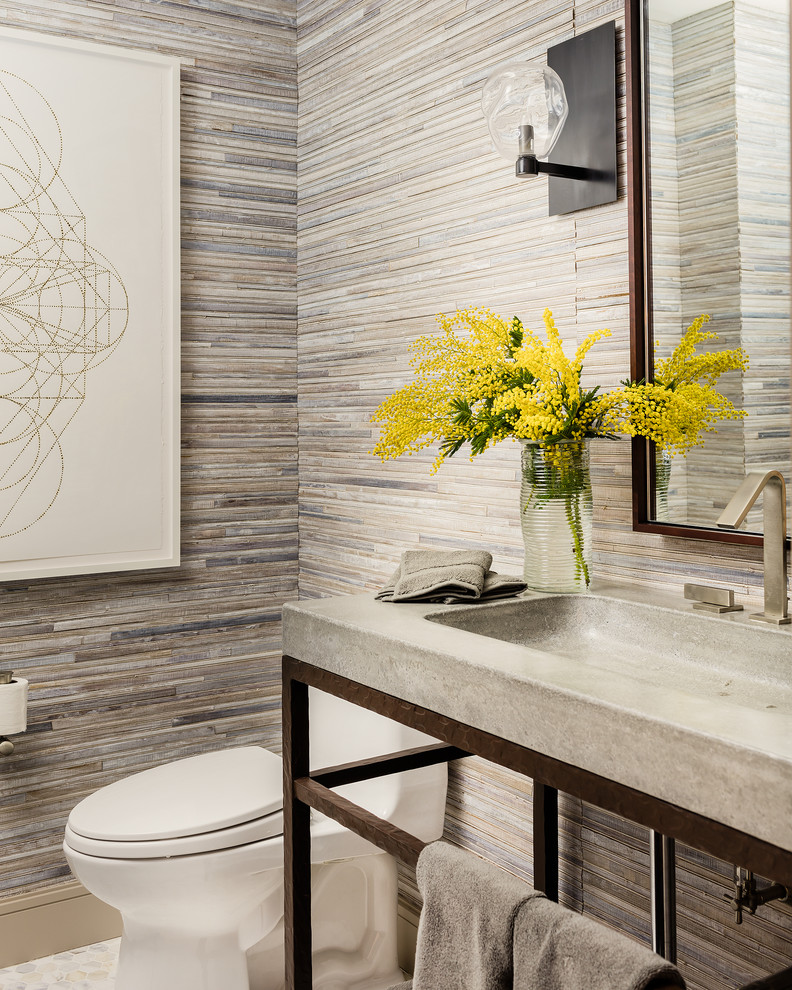 Mid-sized transitional powder room in Boston with a one-piece toilet, beige tile, marble floors, an integrated sink, concrete benchtops and matchstick tile.
