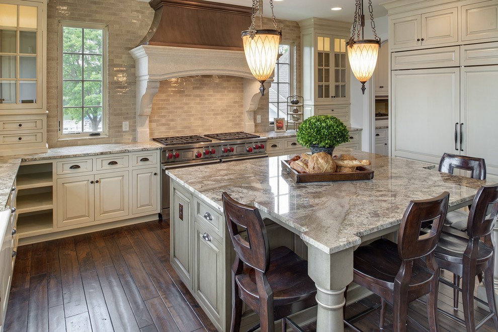 Inspiration for an u-shaped eat-in kitchen in Minneapolis with a farmhouse sink, distressed cabinets, granite benchtops, beige splashback, subway tile splashback, panelled appliances, dark hardwood floors and with island.