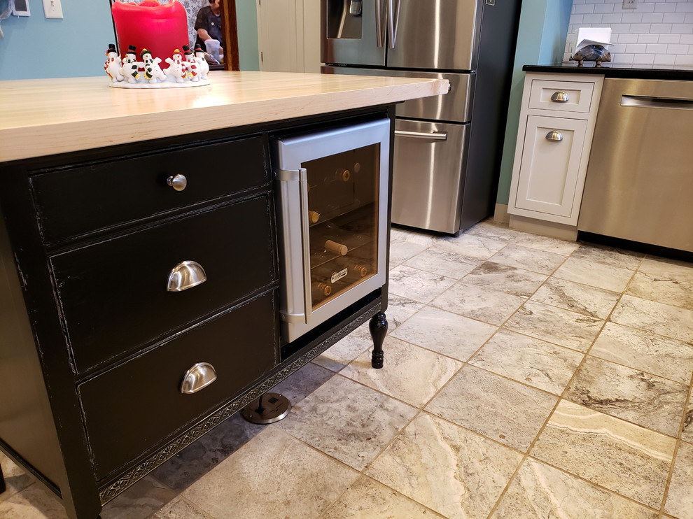 Large transitional u-shaped ceramic tile and beige floor kitchen pantry photo with recessed-panel cabinets, gray cabinets, wood countertops, stainless steel appliances, an island and beige countertops