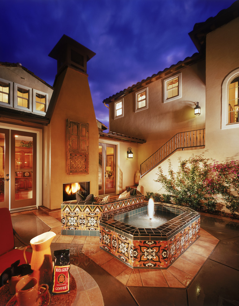 Inspiration for a mid-sized mediterranean courtyard patio in San Diego with a water feature, concrete slab and no cover.