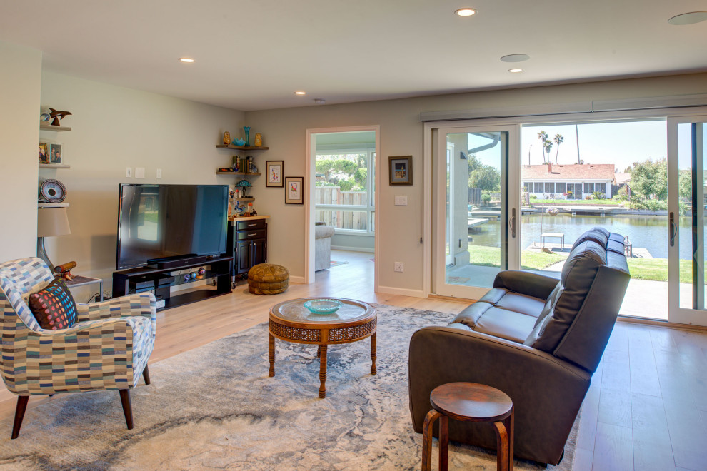 Medium sized classic living room in San Francisco with a freestanding tv and brown floors.
