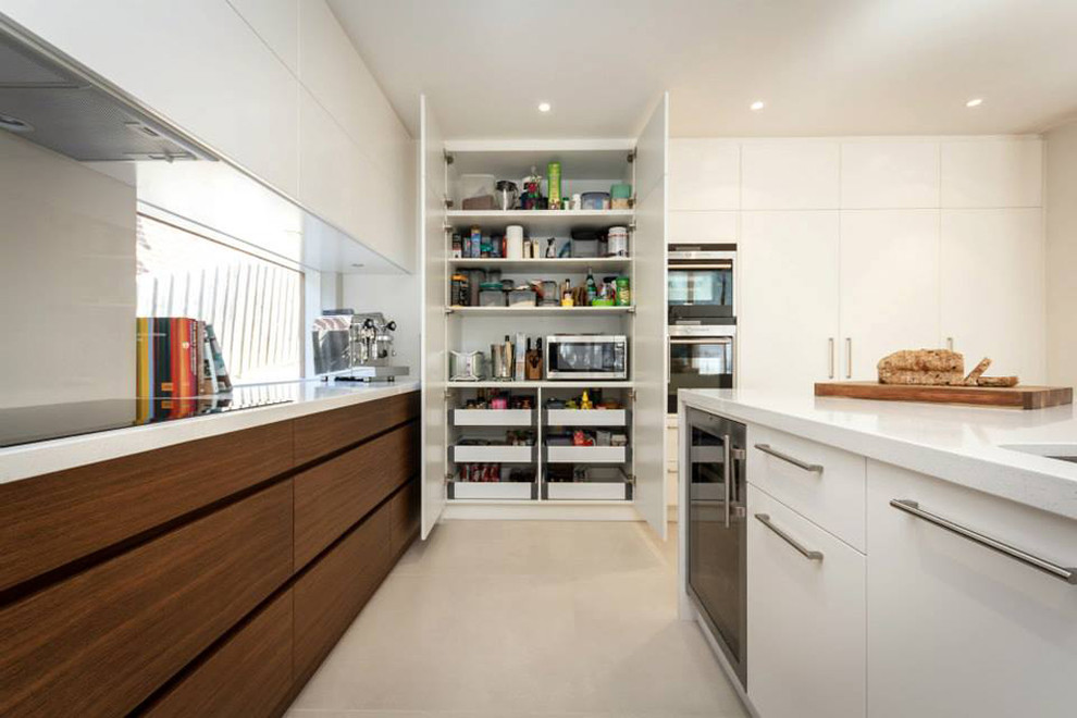 Photo of a contemporary u-shaped eat-in kitchen in Melbourne with an undermount sink, recessed-panel cabinets, white cabinets, quartz benchtops, grey splashback, glass sheet splashback and with island.