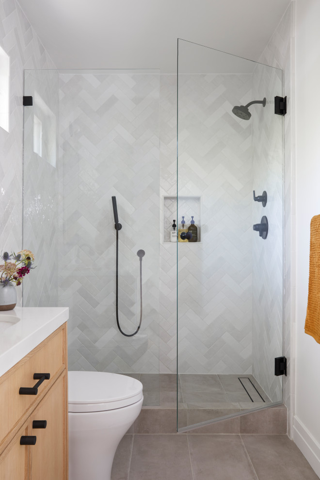Photo of a small scandinavian bathroom in San Francisco with shaker cabinets, brown cabinets, an alcove shower, white tile, ceramic tile, white walls, porcelain floors, an undermount sink, engineered quartz benchtops, grey floor, a hinged shower door, white benchtops, a niche, a single vanity and a built-in vanity.