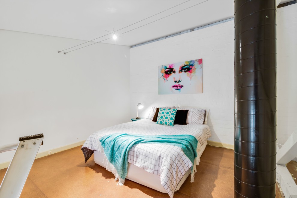 Design ideas for a mid-sized industrial loft-style bedroom in Adelaide with white walls and cork floors.