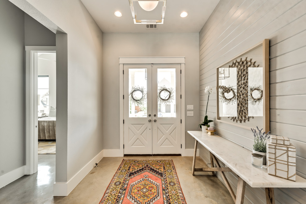 Country foyer in Dallas with concrete floors, a double front door, a white front door and beige floor.