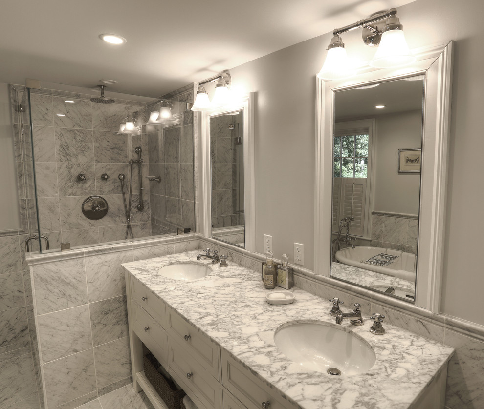Inspiration for a mid-sized country master bathroom in New York with an undermount sink, recessed-panel cabinets, white cabinets, marble benchtops, a freestanding tub, a corner shower, a two-piece toilet, gray tile, stone tile, grey walls and marble floors.