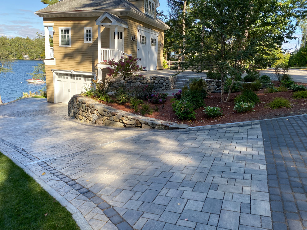 Photo of a large eclectic sloped full sun formal garden for summer in Boston with with fireplace and concrete pavers.