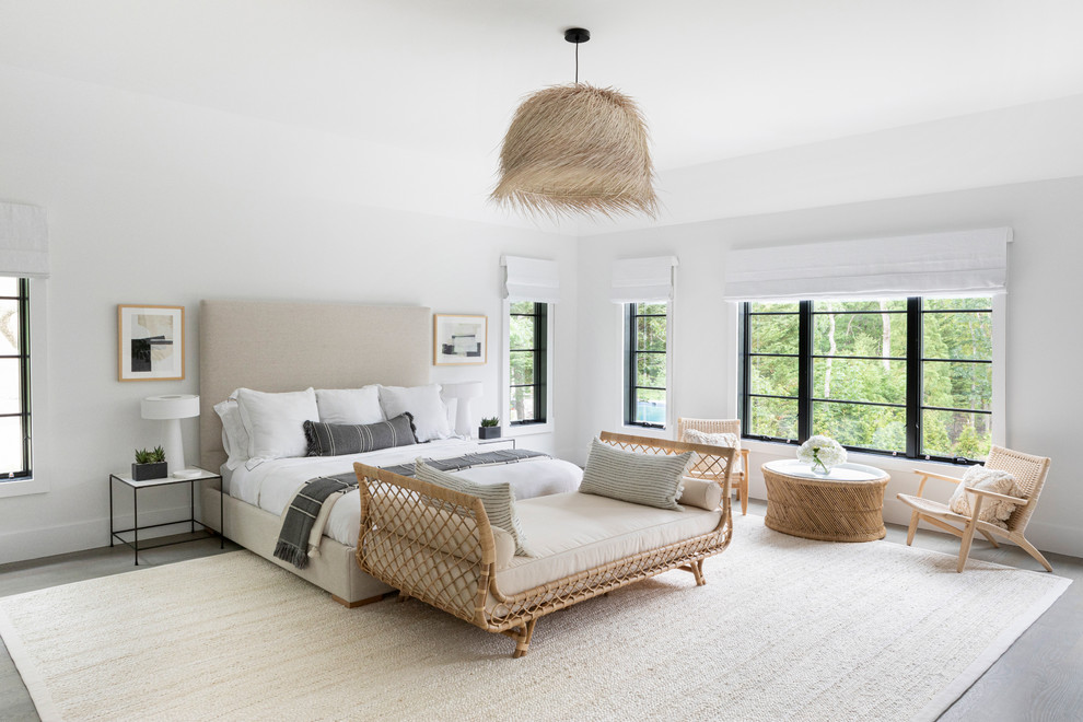 Inspiration for a large beach style master bedroom in New York with white walls, dark hardwood floors and grey floor.