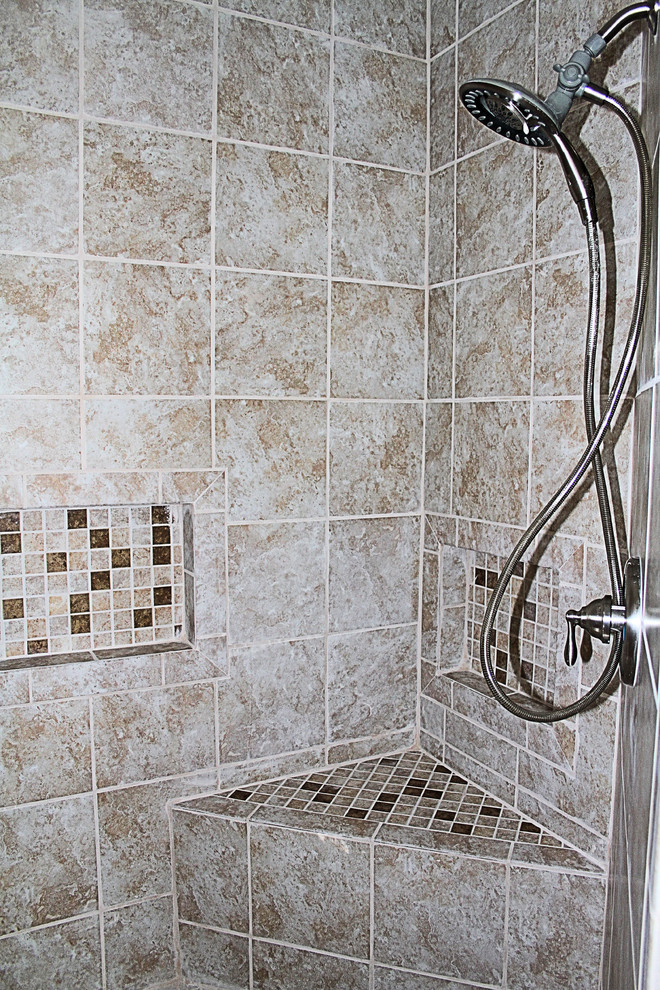 Photo of a beach style bathroom in Wilmington with a curbless shower, beige tile and ceramic tile.