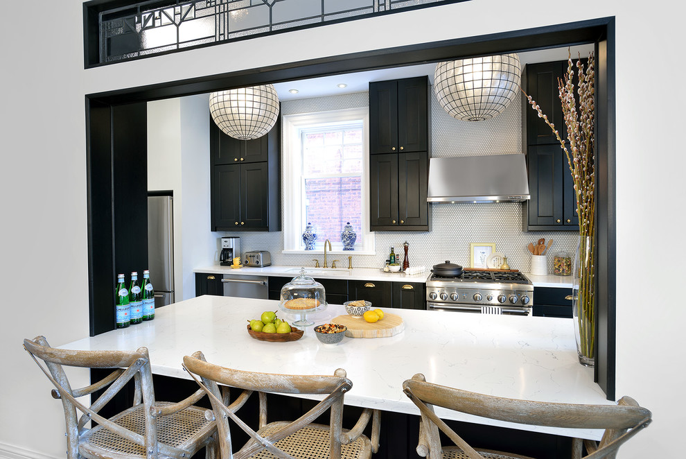 Kitchen - mid-sized transitional galley medium tone wood floor kitchen idea in Toronto with a single-bowl sink, recessed-panel cabinets, black cabinets, quartz countertops, white backsplash and stainless steel appliances