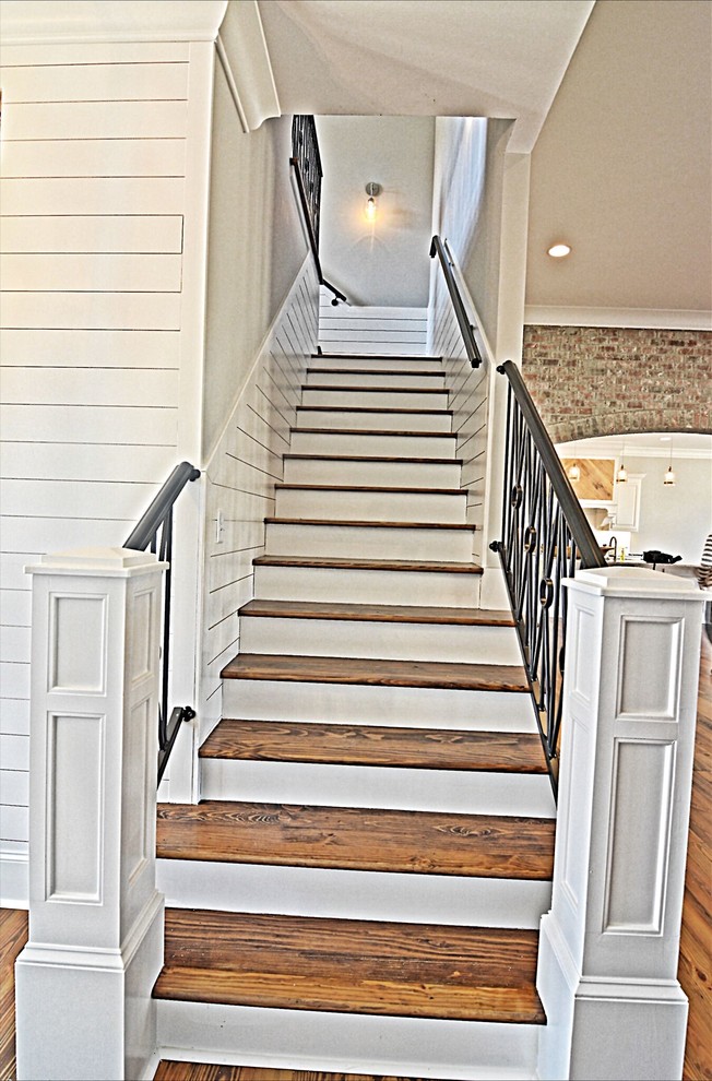 Inspiration for a mid-sized transitional wood straight staircase in Jackson with wood risers and metal railing.
