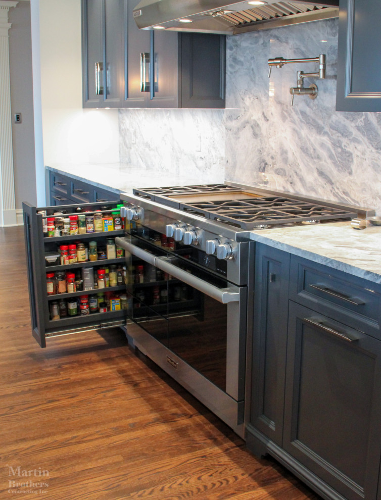Example of a large transitional single-wall medium tone wood floor open concept kitchen design with a double-bowl sink, recessed-panel cabinets, gray cabinets, marble countertops, multicolored backsplash, stainless steel appliances, an island and marble backsplash