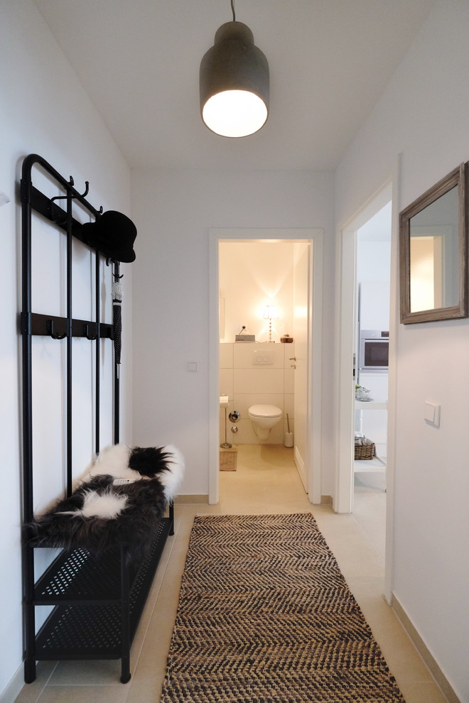 Inspiration for a mid-sized traditional hallway in Dusseldorf with white walls, light hardwood floors and beige floor.
