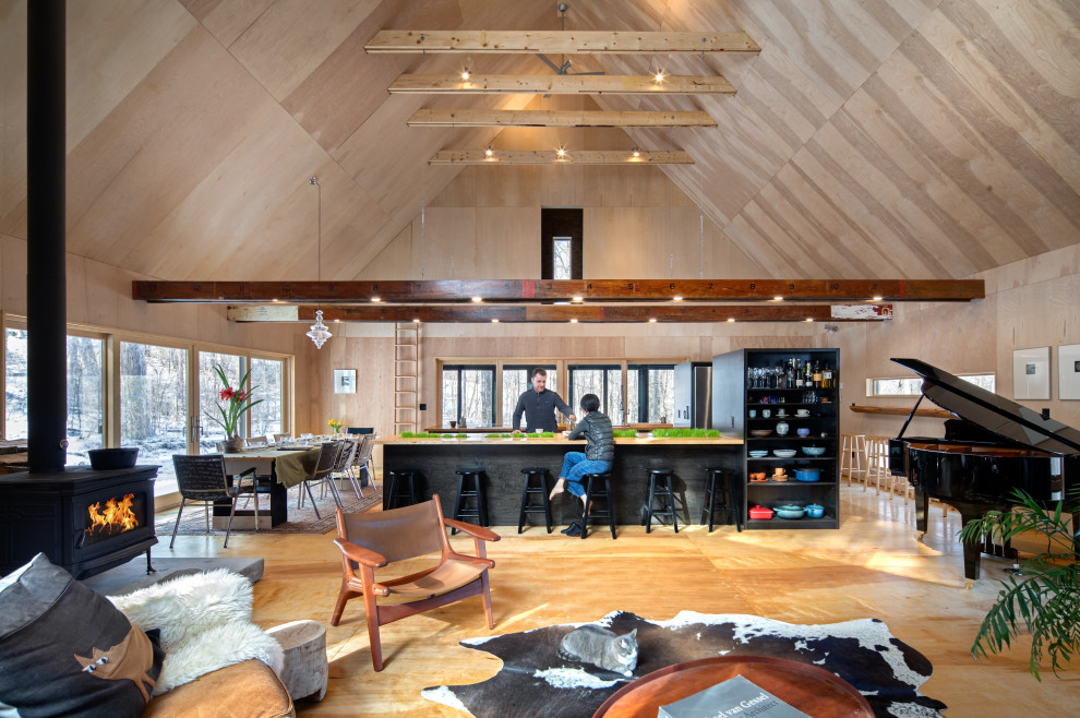 Inspiration for a mid-sized contemporary open concept vaulted ceiling, wood ceiling, wood wall and plywood floor living room remodel in Boston with a wood stove and a concrete fireplace