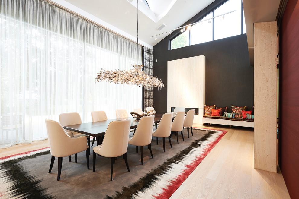 This is an example of an expansive traditional open plan dining in Nuremberg with black walls and medium hardwood floors.