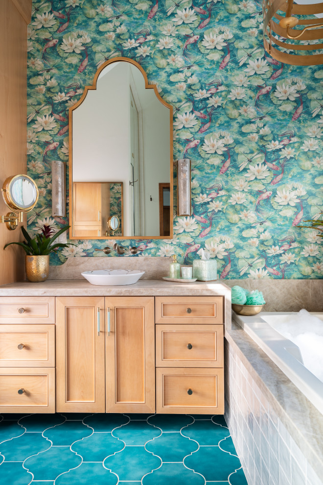 Photo of a mediterranean bathroom in San Diego with recessed-panel cabinets, light wood cabinets, a built-in bath, multi-coloured walls, a vessel sink, blue floors, beige worktops, a single sink, a built in vanity unit and wallpapered walls.