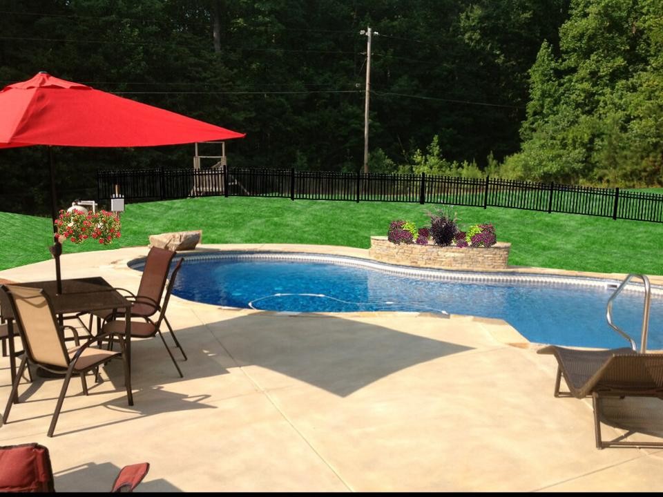 Pool - large transitional backyard concrete and custom-shaped pool idea in Atlanta