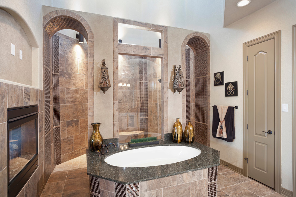 Example of a transitional glass tile porcelain tile doorless shower design with an undermount tub and beige walls