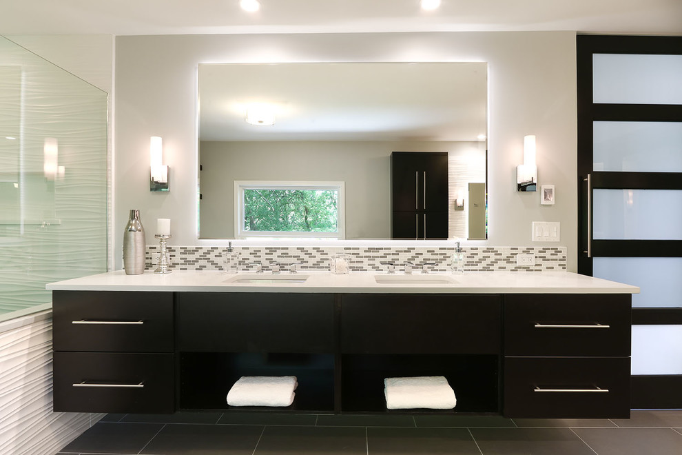 Design ideas for a large contemporary master bathroom in Chicago with flat-panel cabinets, dark wood cabinets, a drop-in tub, an open shower, a one-piece toilet, multi-coloured tile, glass tile, beige walls, porcelain floors, an undermount sink and engineered quartz benchtops.