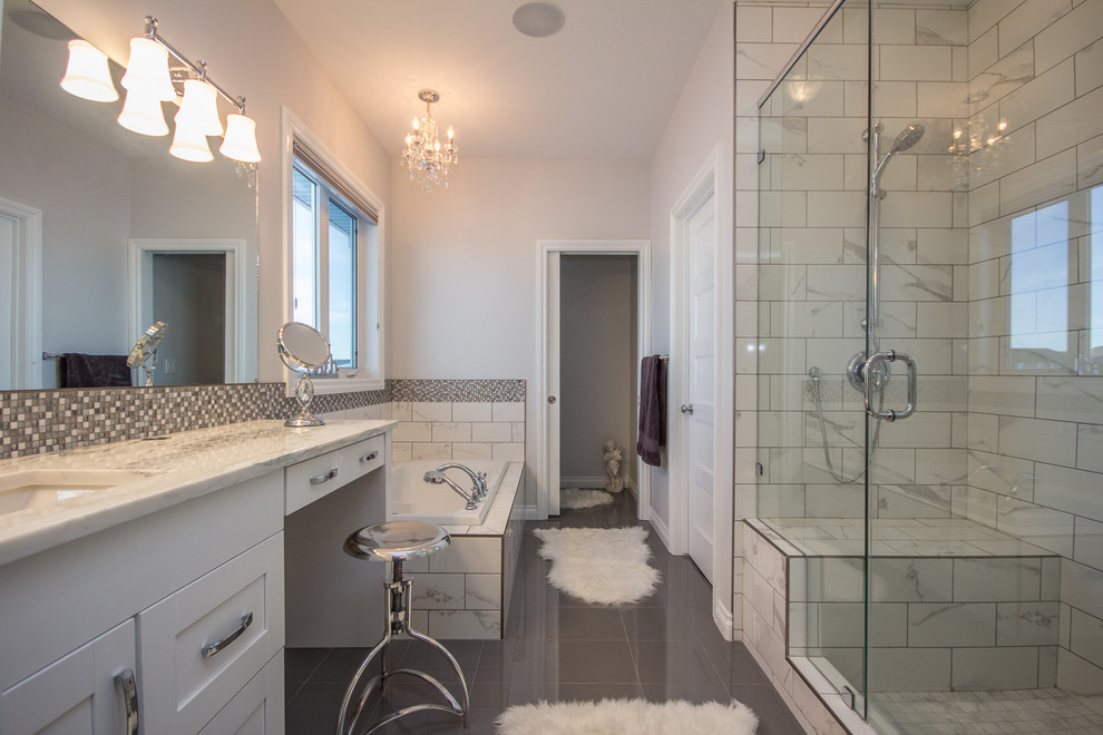 Corner bathtub - large transitional master multicolored tile and mosaic tile porcelain tile corner bathtub idea in Calgary with shaker cabinets, white cabinets, white walls, an undermount sink and quartzite countertops
