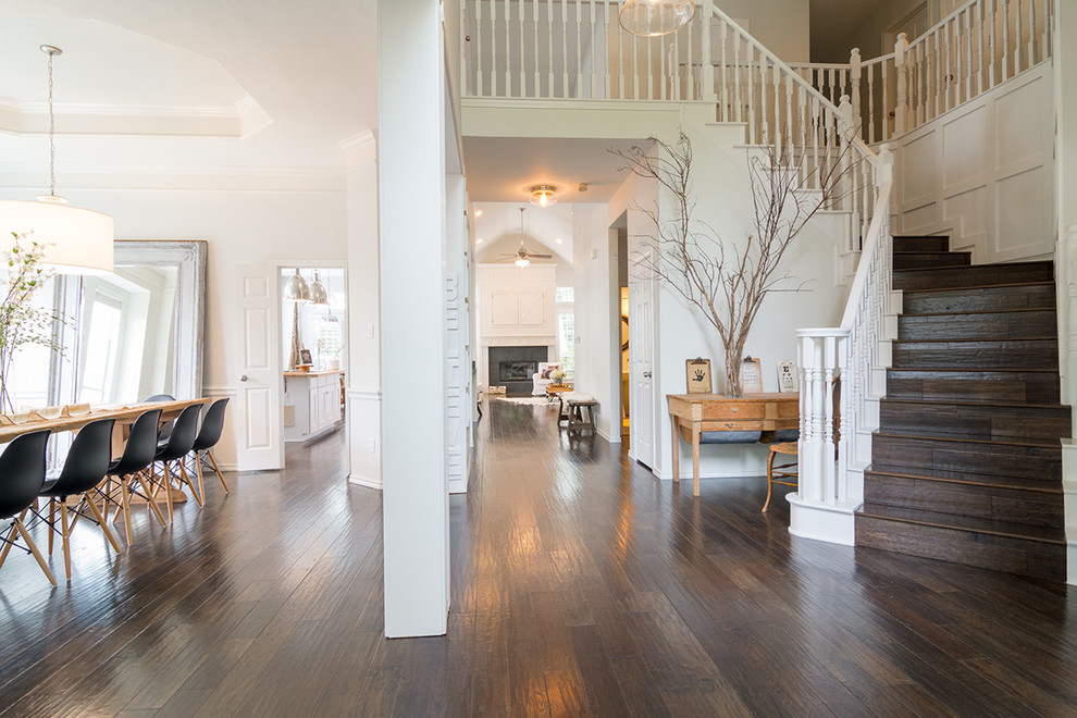 Example of a large mountain style dark wood floor foyer design in Dallas with white walls