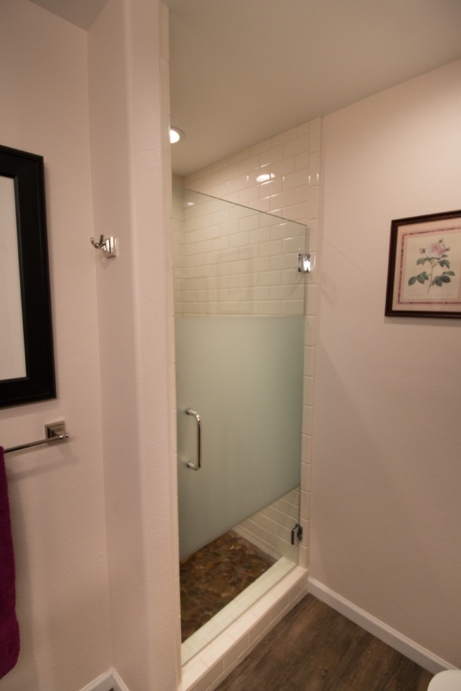 Mid-sized transitional master white tile and subway tile brown floor bathroom photo with flat-panel cabinets, dark wood cabinets, a two-piece toilet, pink walls, an undermount sink and quartz countertops