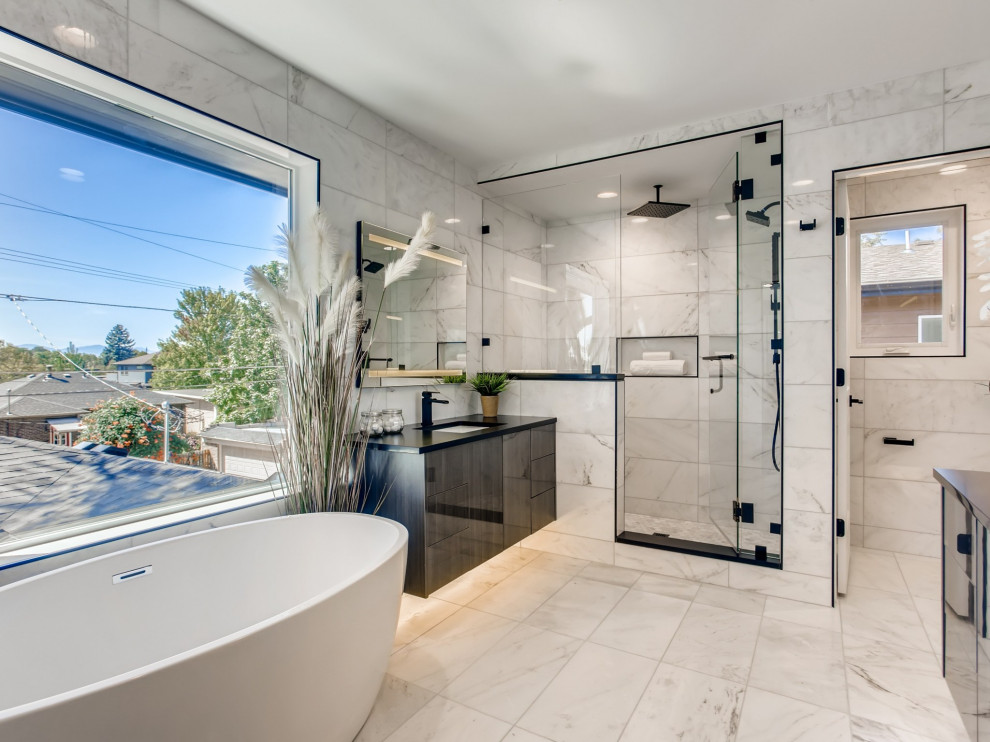 Design ideas for a large contemporary master bathroom in Denver with a freestanding tub, an alcove shower, a one-piece toilet, white tile, white walls, an undermount sink, white floor, a hinged shower door, black benchtops, a double vanity and a floating vanity.
